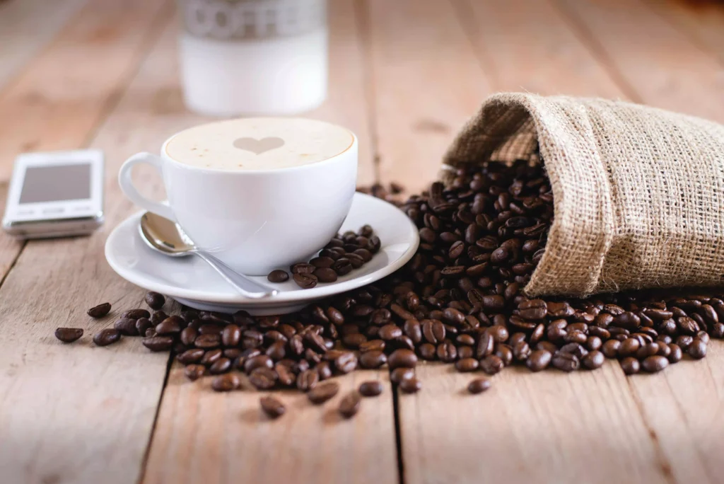 a cup of coffee with milk on a wooden table