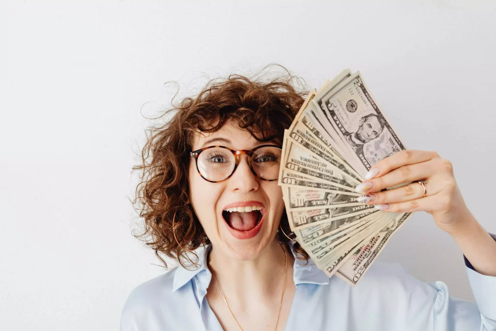 a women with glasses holding money