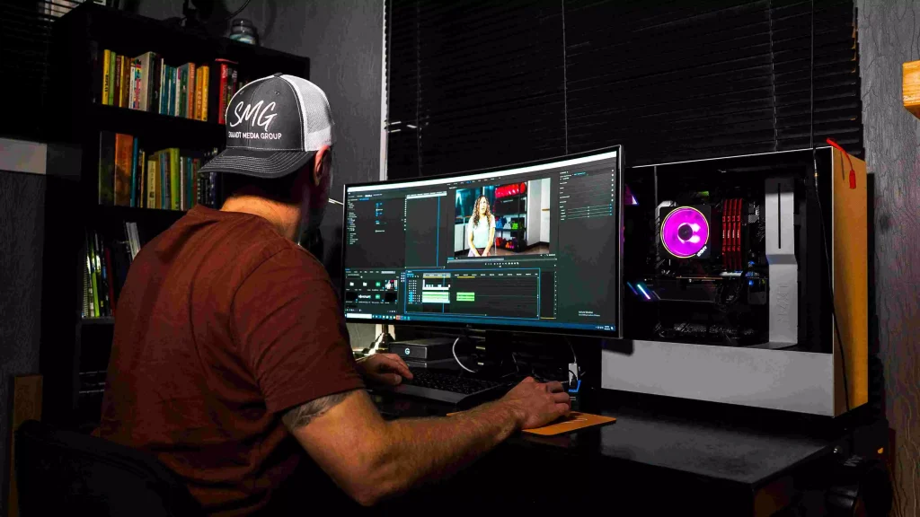 a man in a cap working on his computer 