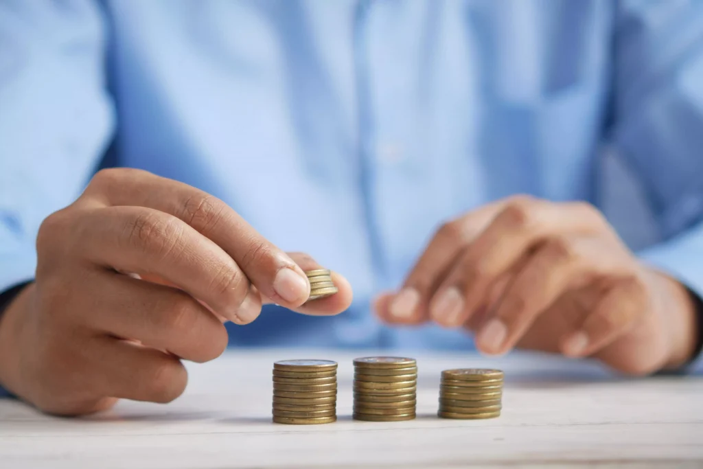 a man in a blue shirt stacking coins