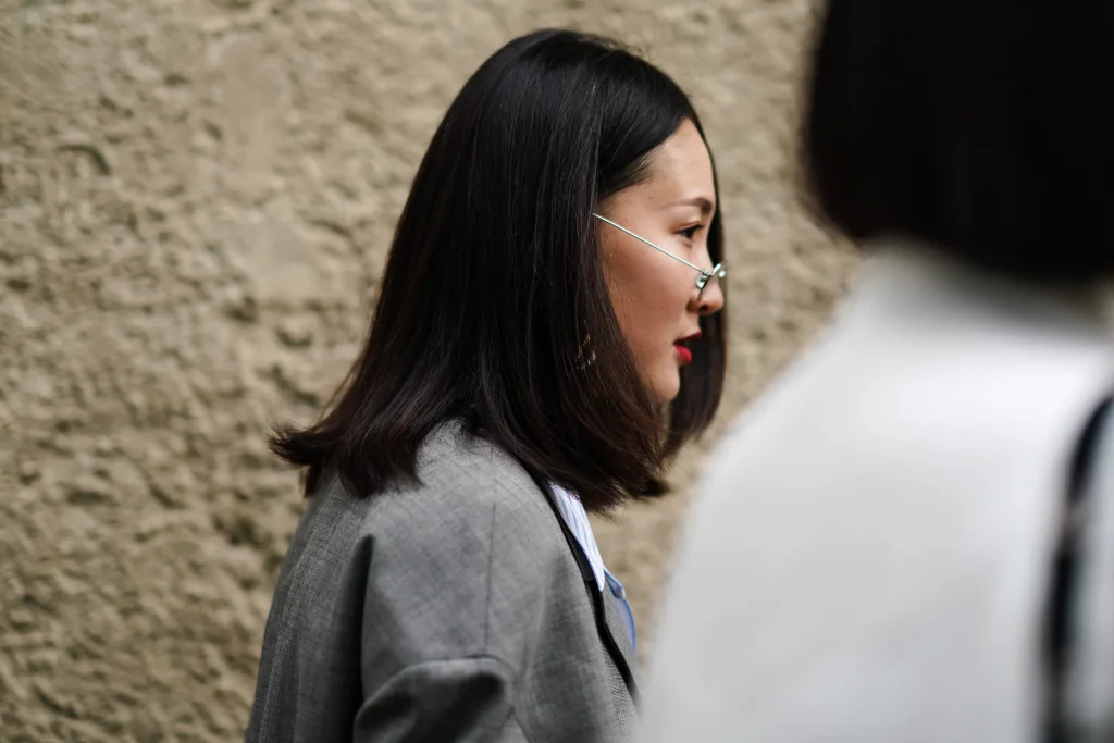 a women with glasses in a grey suit