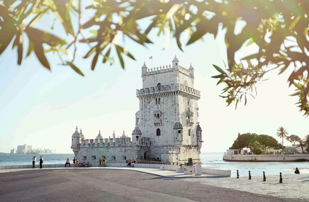 a white castle next to the sea