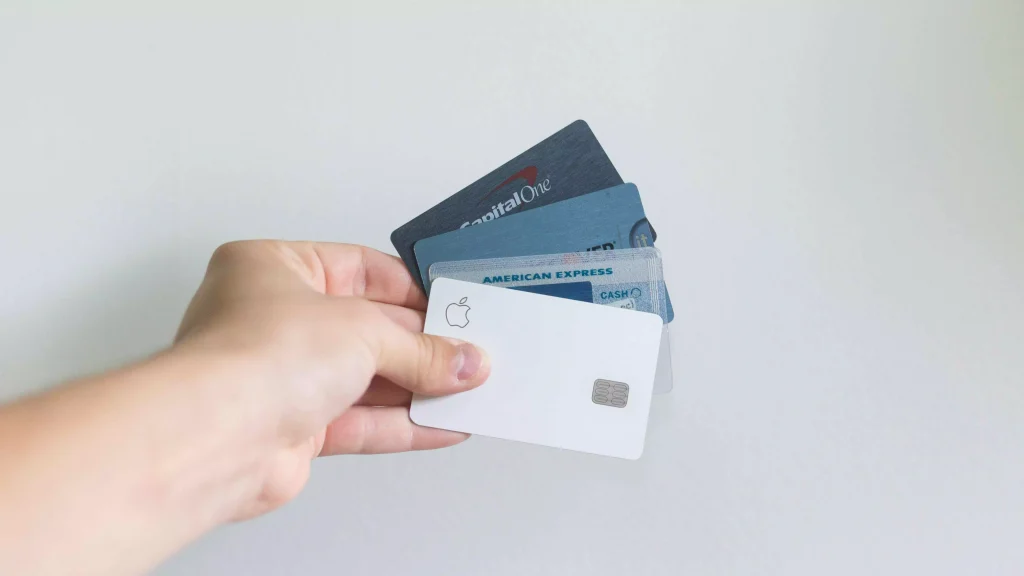 a person holding multiple credit cards