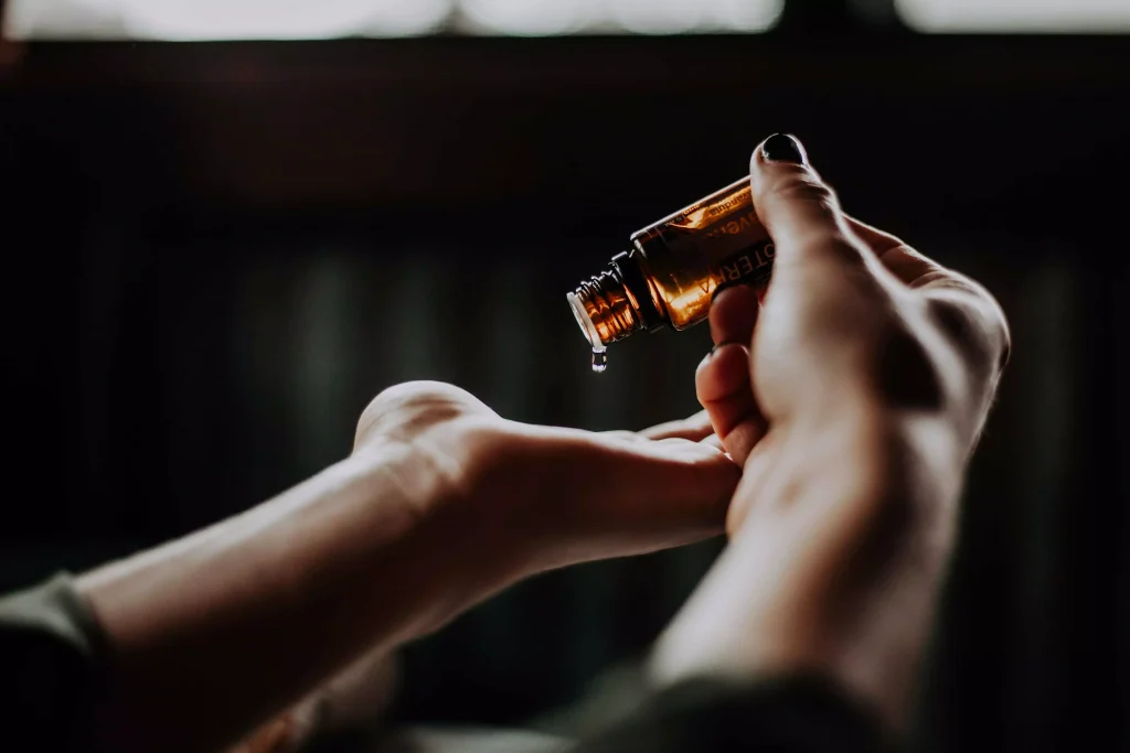 a person putting lotion in the palm of the hand