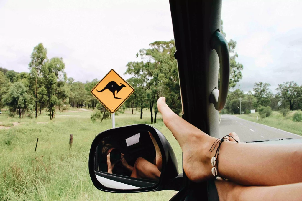 a person with a bracelet photographing the mirror in the car