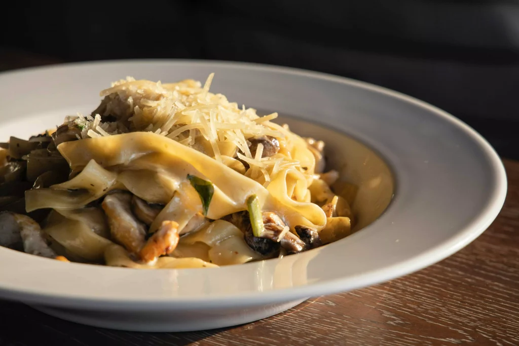 a white porcelain plate full of pasta