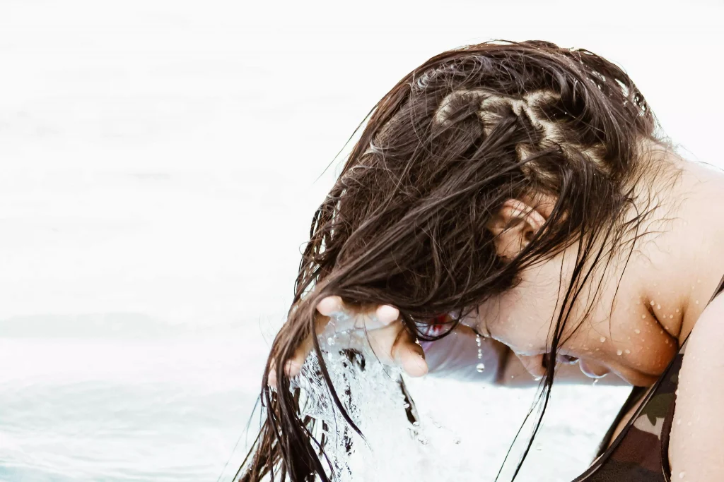 a women washing hair in a pool