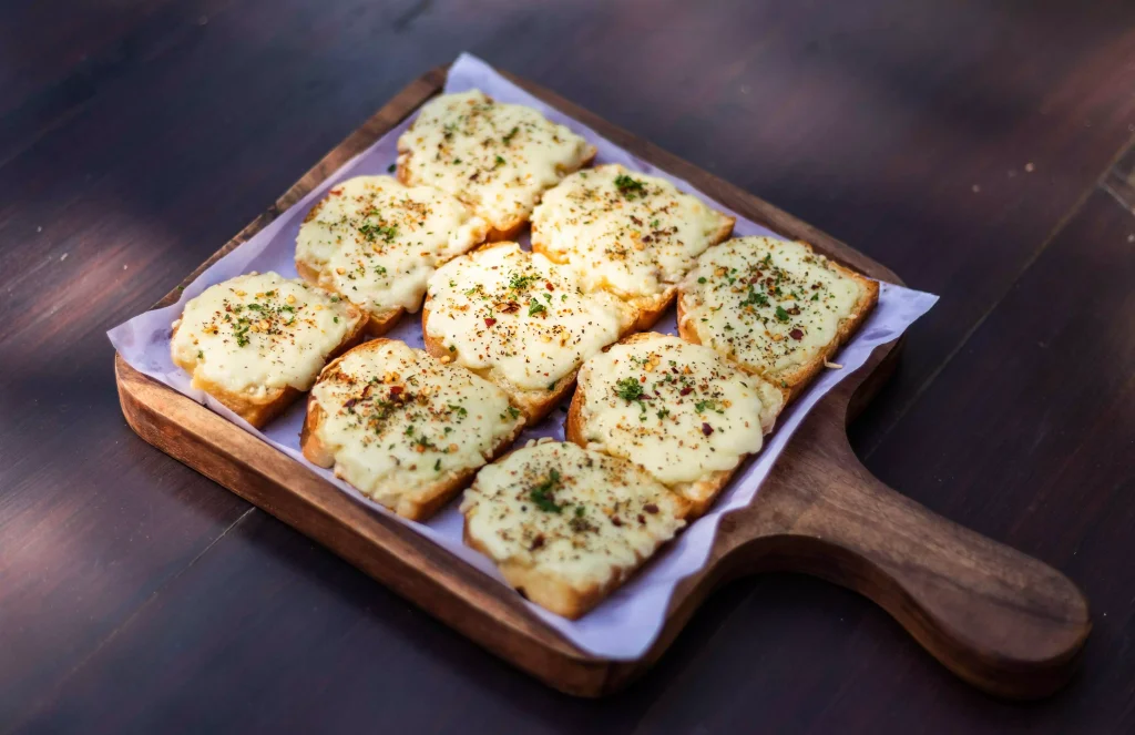 bread with cheese and vegetables on top of it