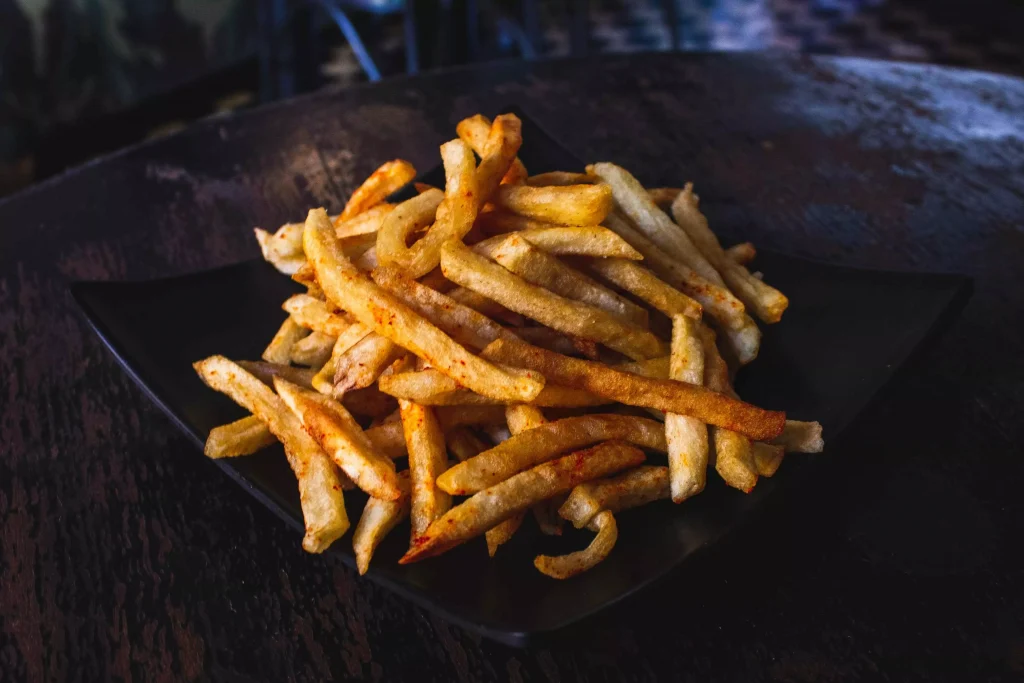 French fries in a black color plate