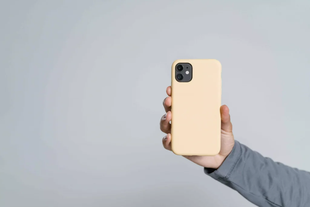 a person in a grey shirt holding a phone