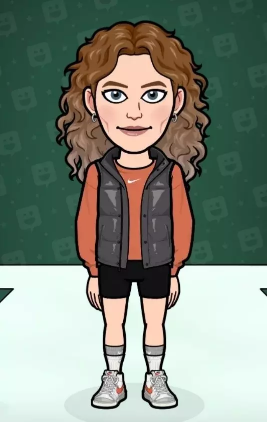 a girl with curly hair in a vest and an orange shirt