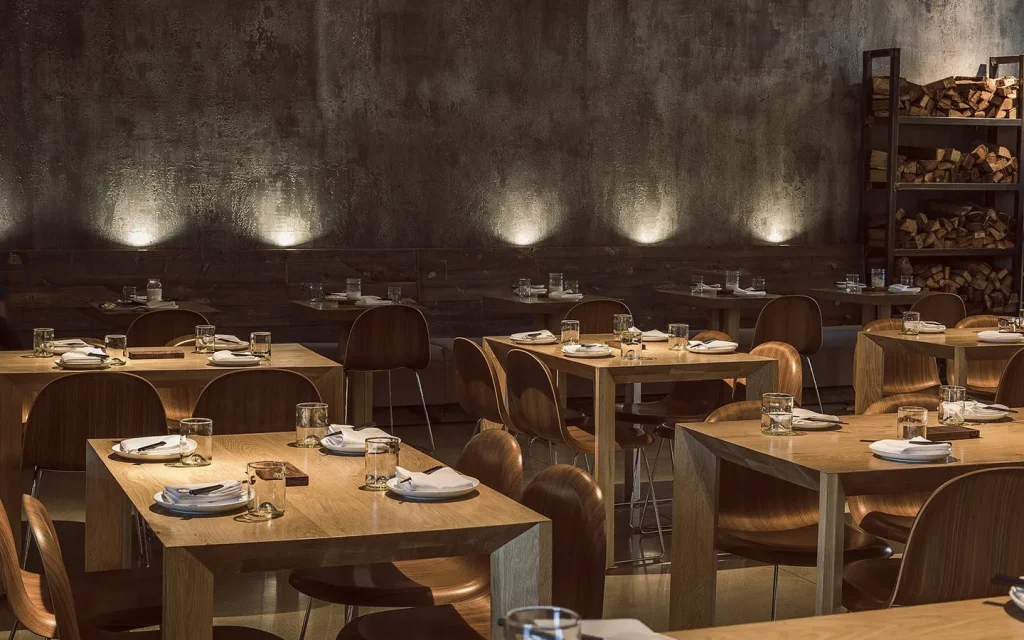 wooden tables photographed in front of a black color wall